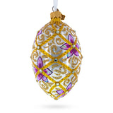 Purple Flowers on Golden Scroll Glass Egg Christmas Ornament 4 Inches in White color, Oval shape