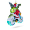 Playful Alligator Riding Bicycle with Gifts - Blown Glass Christmas Ornament ,dimensions in inches: 4.45 x 2.05 x 5
