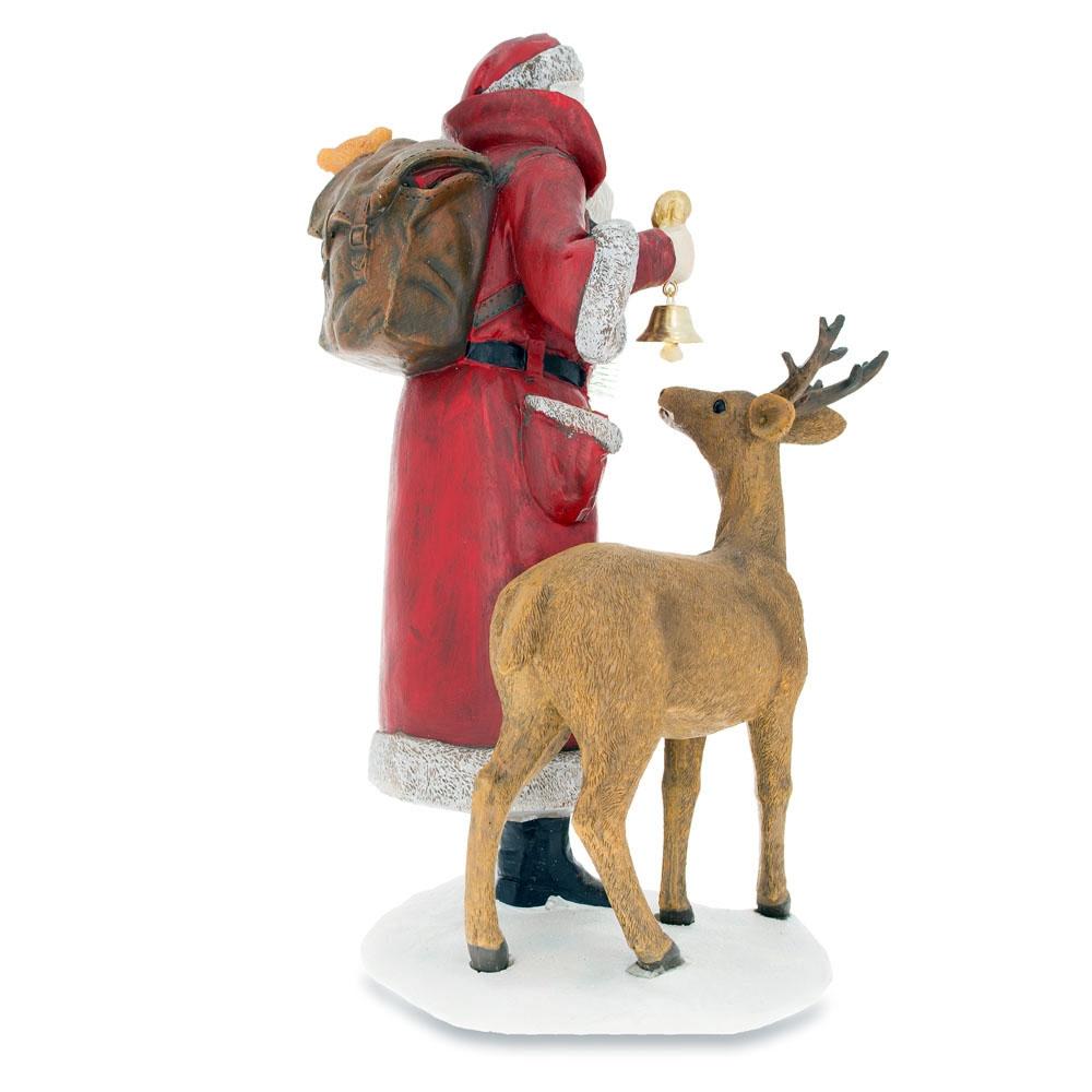 Santa Holding Christmas Tree and Bell by Reindeer Figurine 12 InchesChina , dimensions in inches: 12 x 5.1 x 5.1