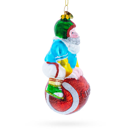 Santa Football Player with Sports Ball Blown Glass Christmas Ornament , dimensions in inches: 5 x 4 x