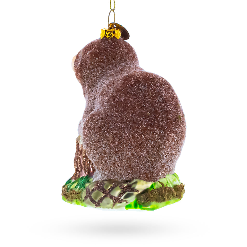 Beaver Holding a Log Glass Christmas OrnamentChina , dimensions in inches: 4.34 x 3.67 x 2.49