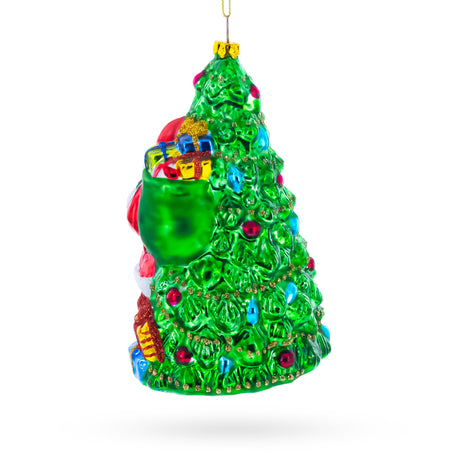 Jolly Santa by Tree Blown Glass Christmas Ornament , dimensions in inches: 6 x 3.9 x 3.6
