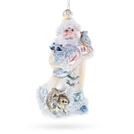 Santa Holding Cardinal and Raccoon Glass Christmas Ornament in White color