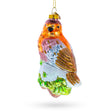 Bird Perched on Snowy Tree Branch Glass Christmas Ornament in  color