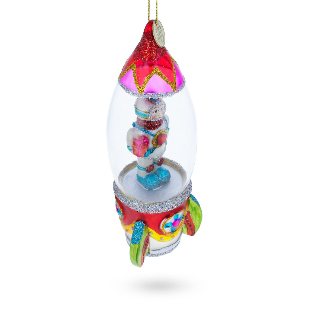 Trailblazing Astronaut Inside Spaceship Blown Glass Christmas OrnamentChina , dimensions in inches: 6.5 x 2.29 x 2.09