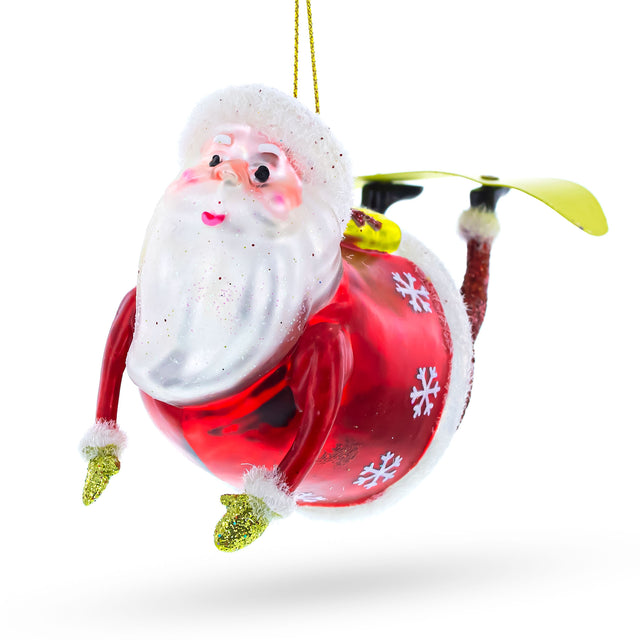 Santa Snowboarding Blown Glass Christmas Ornament in Red color