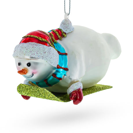 Snowman Gleefully Riding a Sled - Blown Glass Christmas Ornament in White color,  shape