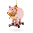 Playful Pig Riding a Skateboard - Blown Glass Christmas Ornament in Pink color,  shape