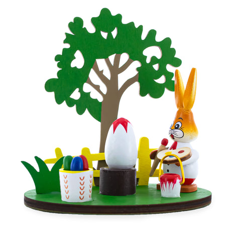 Wooden Bunny Figurine Decorating Easter Eggs in Green color