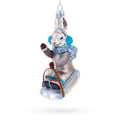 Bunny Sledding with Earmuffs Glass Christmas Ornament in Grey color Figurine