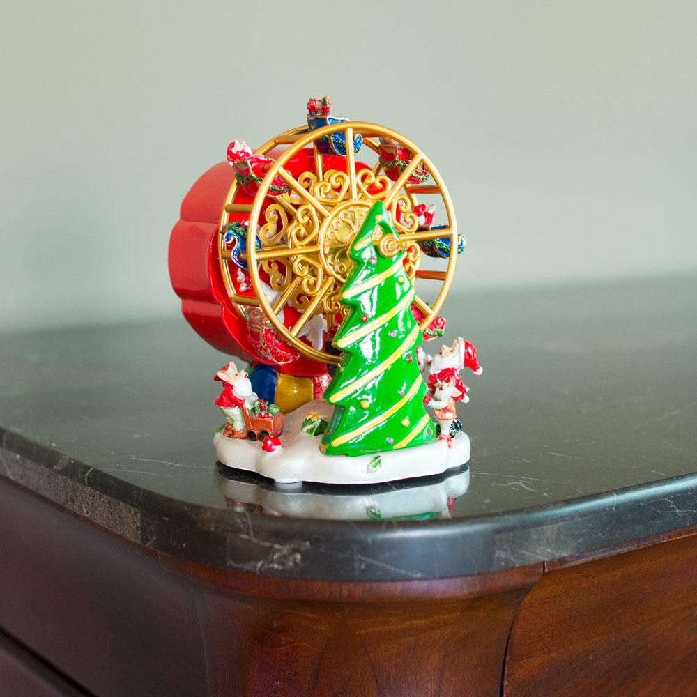 Festividad de la noria de Papá Noel: figura musical giratoria con árbol de Navidad