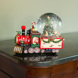 Holiday Express: Globo de nieve acuático musical con niños viajando en tren y árbol de Navidad