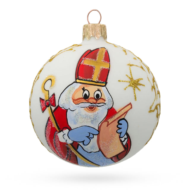 St. Nicholas Perusing His Gift List  Glass Ball Christmas Ornament 3.25 Inches in White color Round
