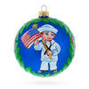 Glass Anchors Aweigh: USA Navy Soldier with American Flag Blown Glass Ball Patriotic Christmas Ornament 4 Inches in Blue color Round