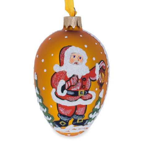 Santa With Lantern Glass Christmas Ornament 4 Inches in Gold color, Oval shape