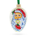 Santa Holding Candle Glass Egg Ornament 4 Inches in White color Oval