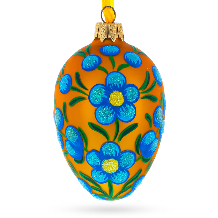 Blue Flowers on Orange Glass Egg Ornament 4 Inches in Gold color Oval