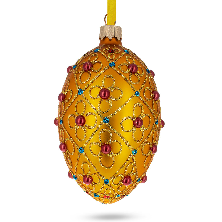 Glass Red Beads, Blue Crystals & Filigree Trellis Glitter on Gold Glass Egg Ornament 4 Inches in Gold color Oval