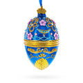 Flowers on Glossy Blue Glass Egg Christmas Ornament 4 Inches in Blue color Oval