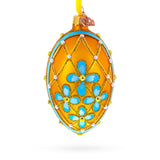 Blue Flowers on Gold Glass Egg Ornament 4 Inches in Yellow color Oval
