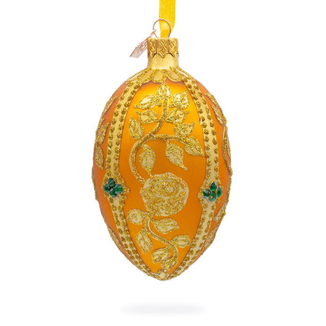Glittered Golden Leaves on Orange Glass Egg Ornament 4 Inches in Gold color, Oval shape