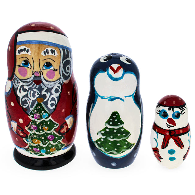 Set of 3 Santa, Penguin and Snowman Wooden Nesting Dolls in Multi color,  shape