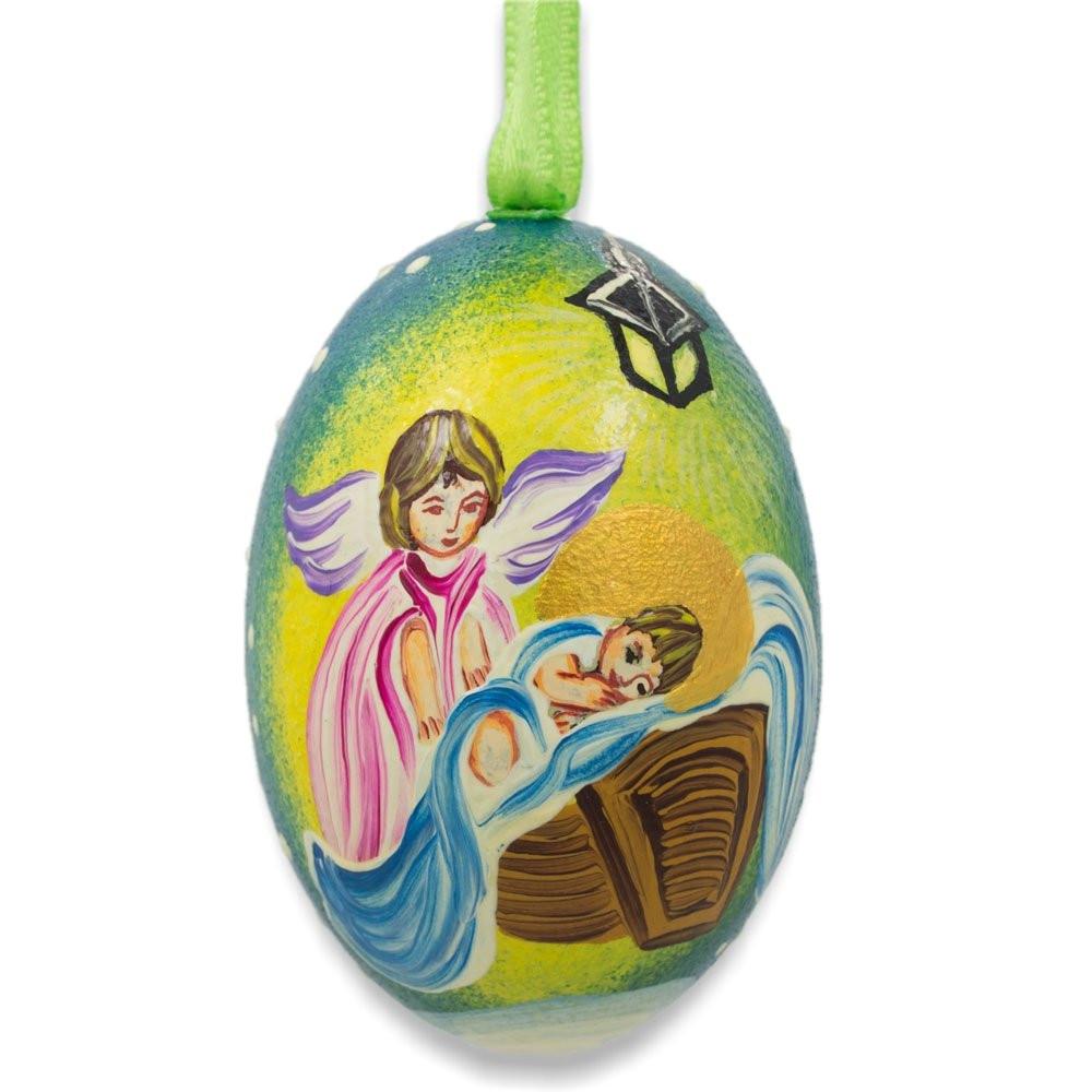Wood Angel Overlooking Baby Jesus Wooden Christmas Ornament 3 Inches in Multi color Oval