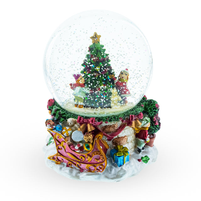 Joyful Children Adorning Christmas Tree: Musical Water Snow Globe in Multi color Round