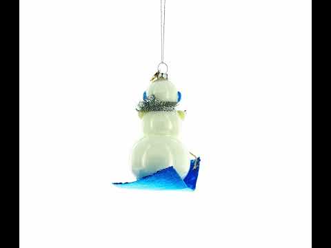 Snowman Riding a Sled Glass Christmas Ornament