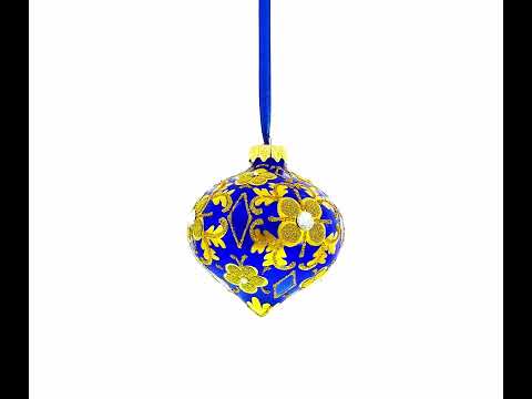 Adorno navideño de vidrio con hojas doradas enjoyadas sobre un remate en forma de cebolla azul