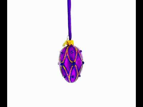 Mini huevo de cristal de 7,35 cm en morado vibrante con detalles en gemas azules y doradas.