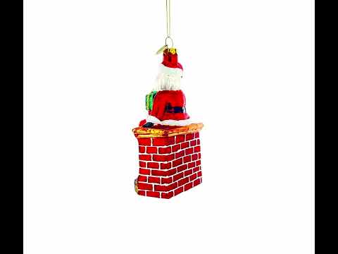 Santa Delivering Presents Down the Chimney Glass Christmas Ornament